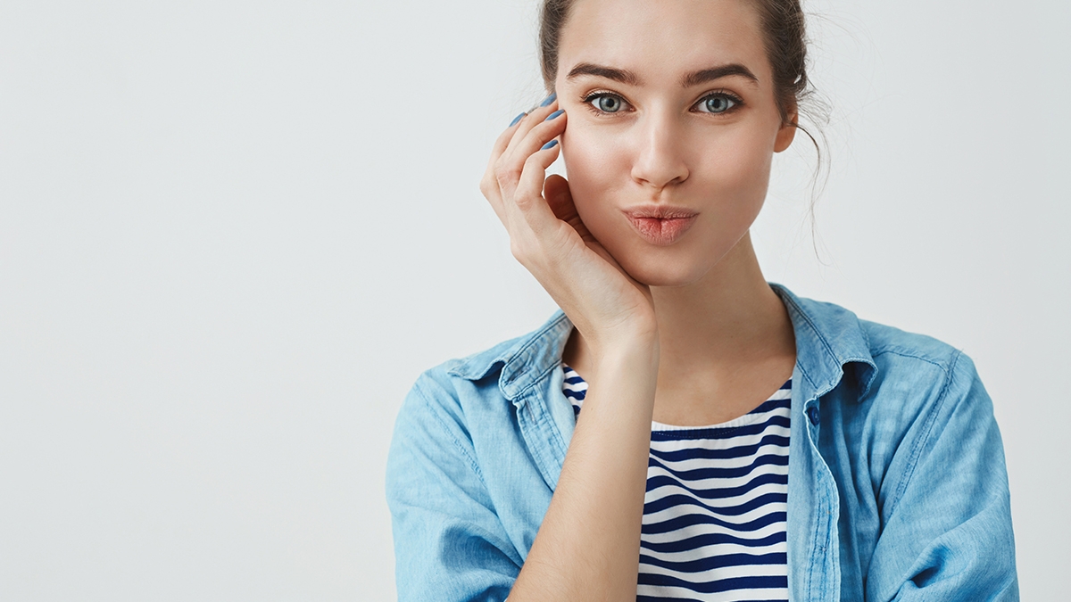 Close-up charming good-looking young mother taking skincare, smiling happy visiting beauty salon done nails, folding lips silly cute, touching cheek, having lucky fantastic day, white background