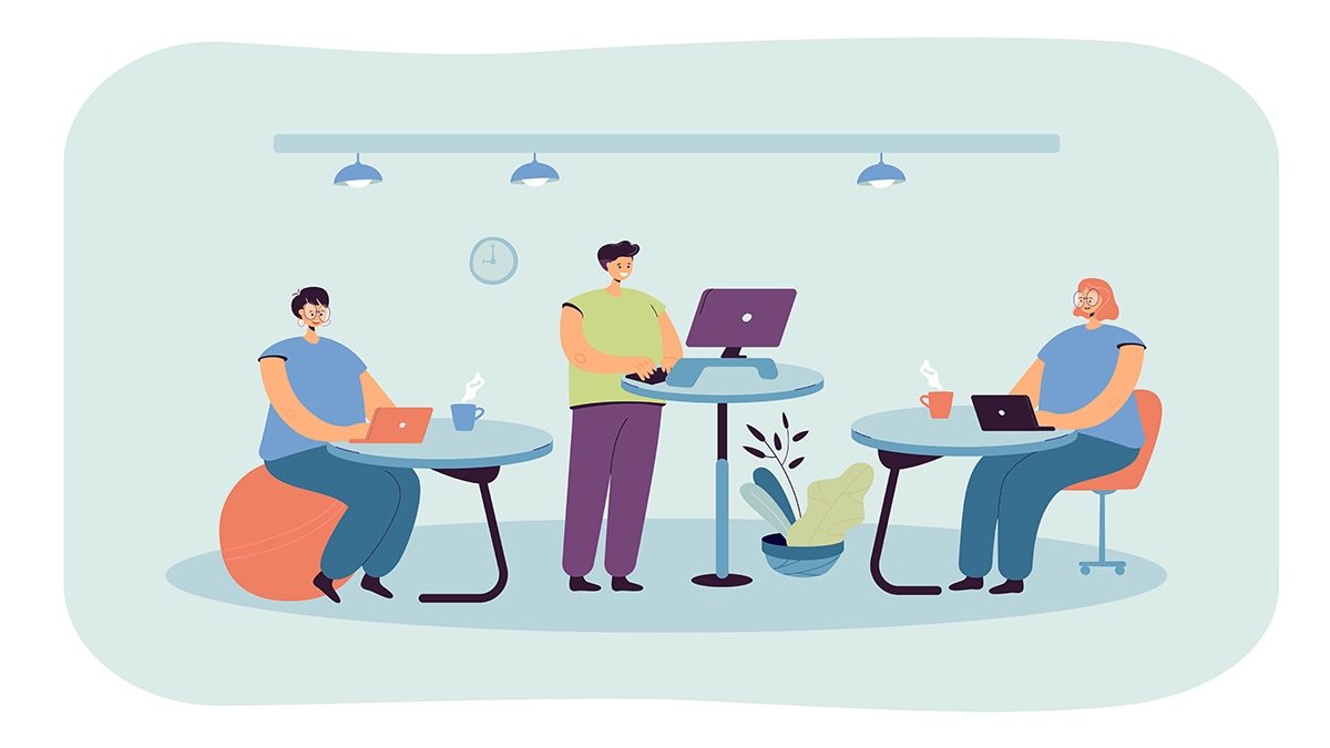 Office employees working at ergonomic workplaces