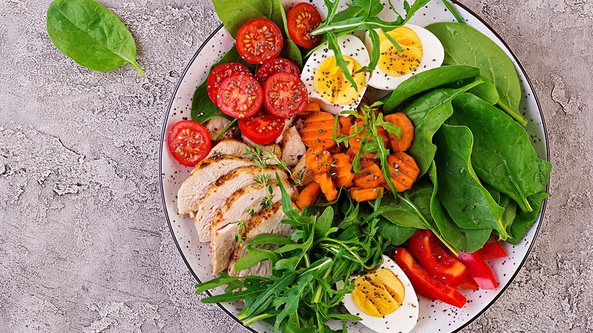 Plate with a keto diet food. Cherry tomatoes, chicken breast, eg