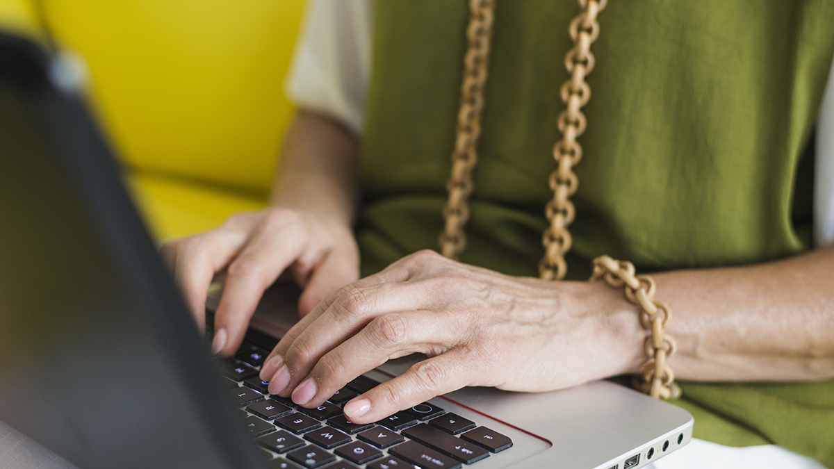 senior-woman-s-hand-laptop-keypad